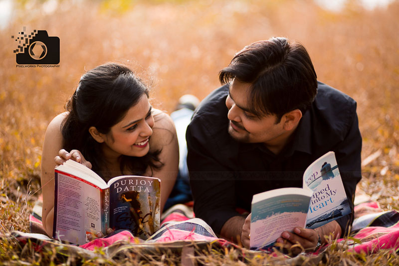 Pre Wedding Shoot Poses lying on the ground reading